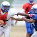 Lincoln's Troy Brumfield carries the ball around E.J. Shaah during a practice at the school on Thursday. Melanie Maxwell I AnnArbor.com